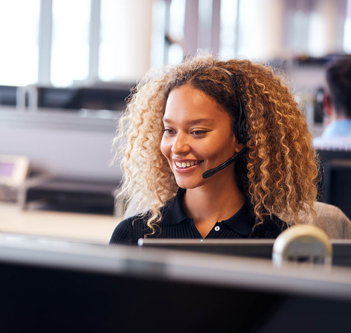 Typing, happy woman in call centre consulting, speaking or talking at customer services.