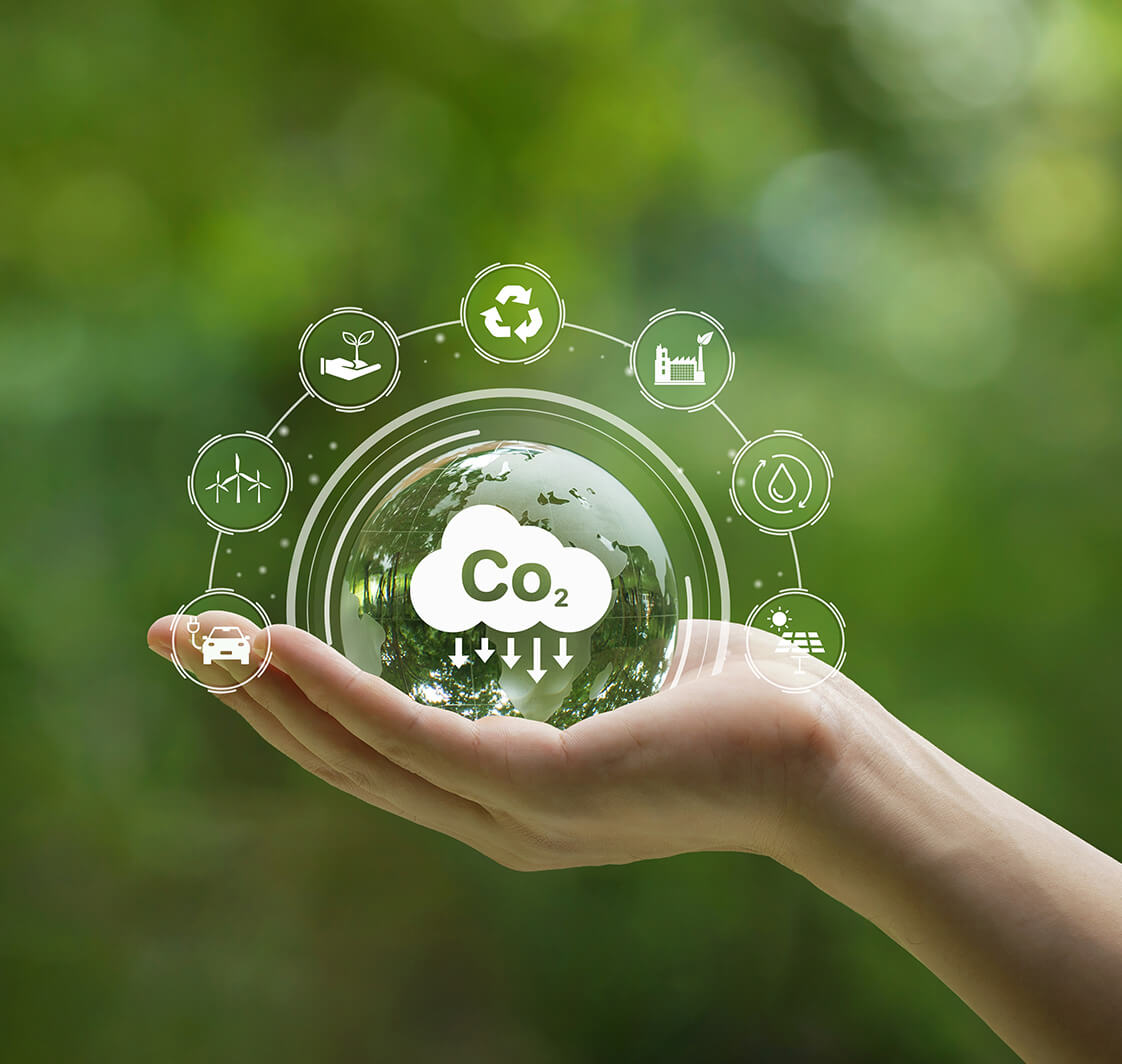 Reduce CO2 emission concept. Hand-holding crystal globe with a CO2 icon. Ideas for Sustainable development and green business based on renewable energy.