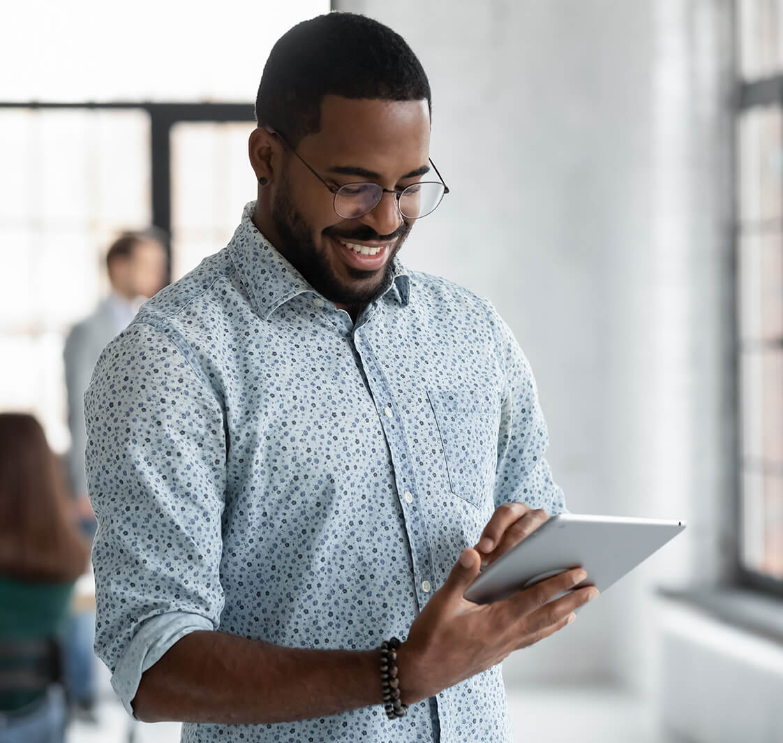 Man looking at a computer tablet.