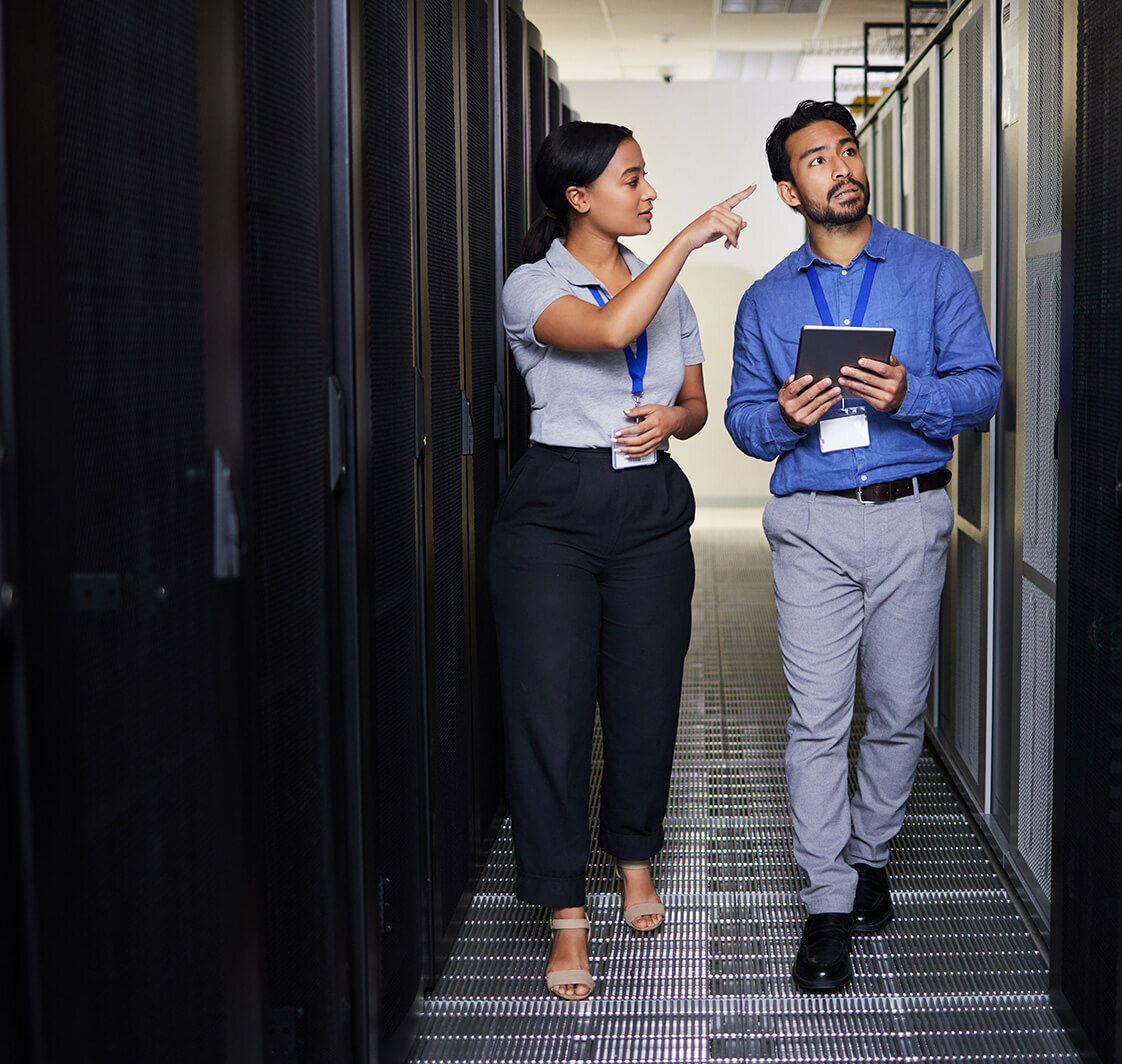 Engineering man and woman or manager walking and check data center with digital technology.