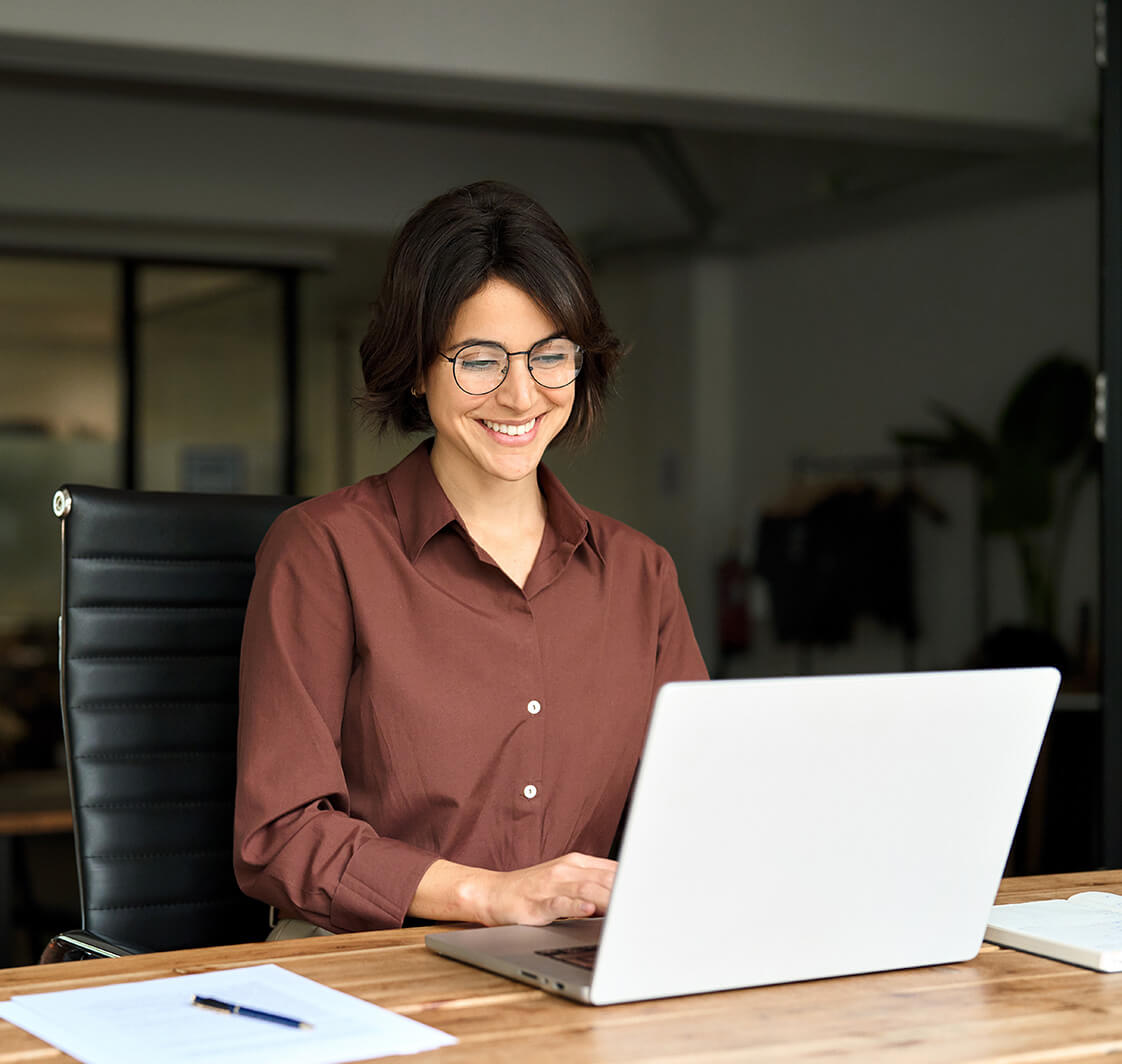 Busy young business woman executive using laptop in office.