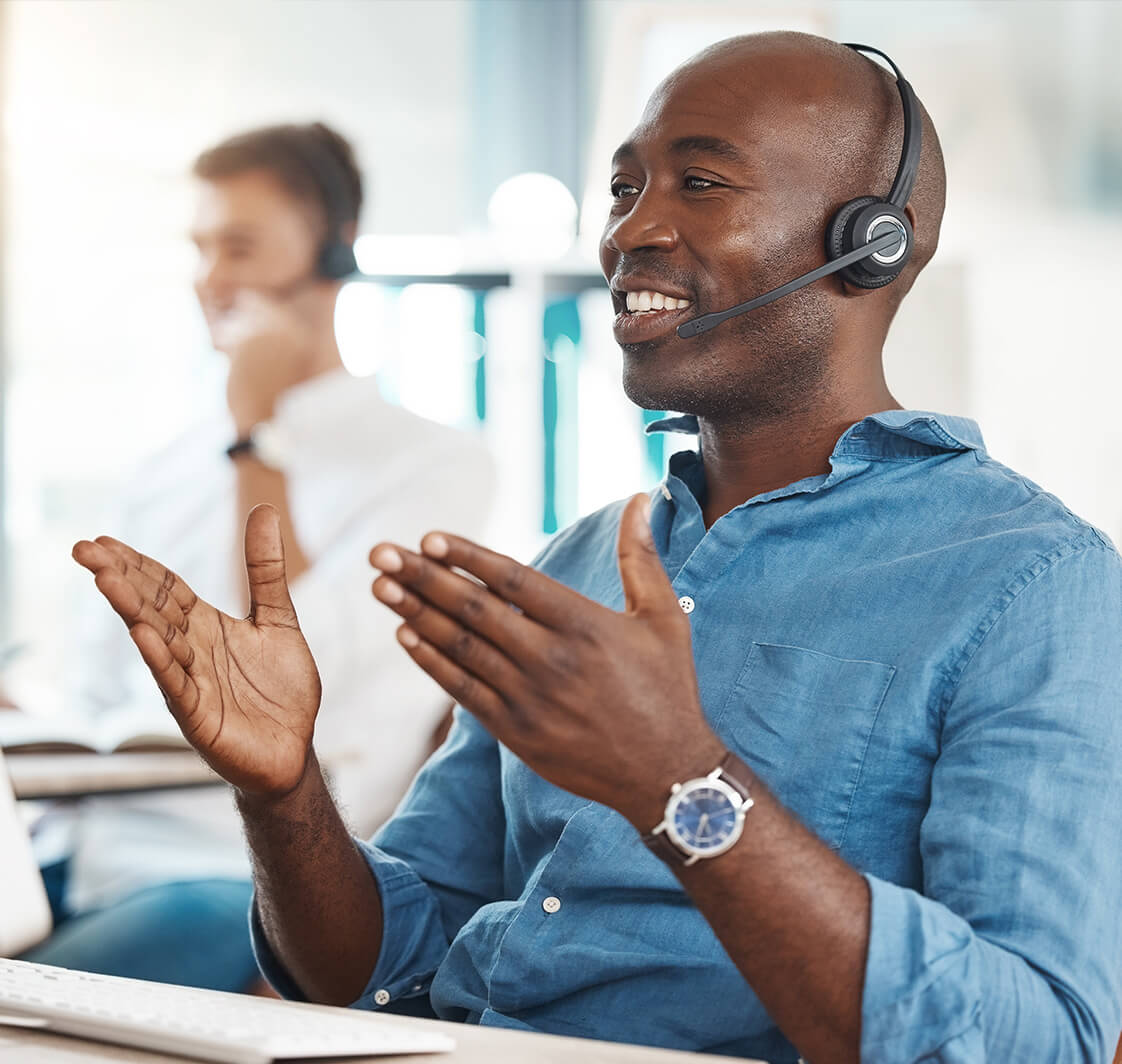 Man working in an office and consulting on a headset.