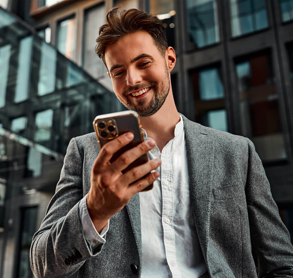 Portrait of a modern man holding a phone while making a corporate call.