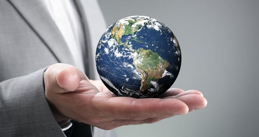 A globe in a hand representing environment, sustainability and governance